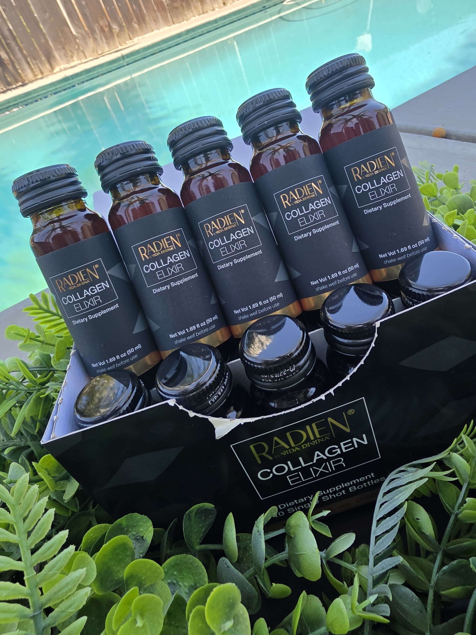 Pack of Radien Collagen Elixir bottles displayed beside a pool, promoting skin health and beauty.